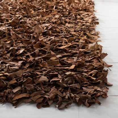 Tapis décoratif moderne SAFAVIEH en cuir shaggy fait main Doinita